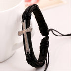 Black braided bracelet with a cross pendant on a white background