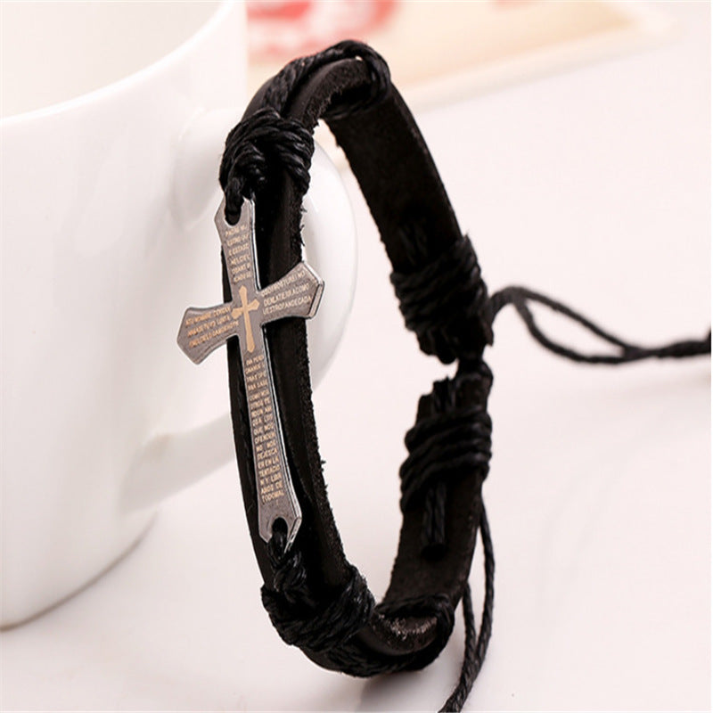 Black braided bracelet with a cross pendant on a white background
