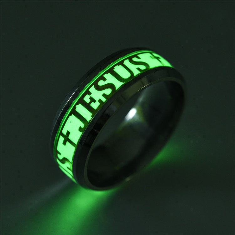Glowing green ring with 'JESUS' engraving on a dark background