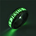 Glowing green ring with 'JESUS' engraving on a dark background