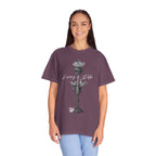 Person wearing a purple t-shirt with a graphic design and text on a white background
