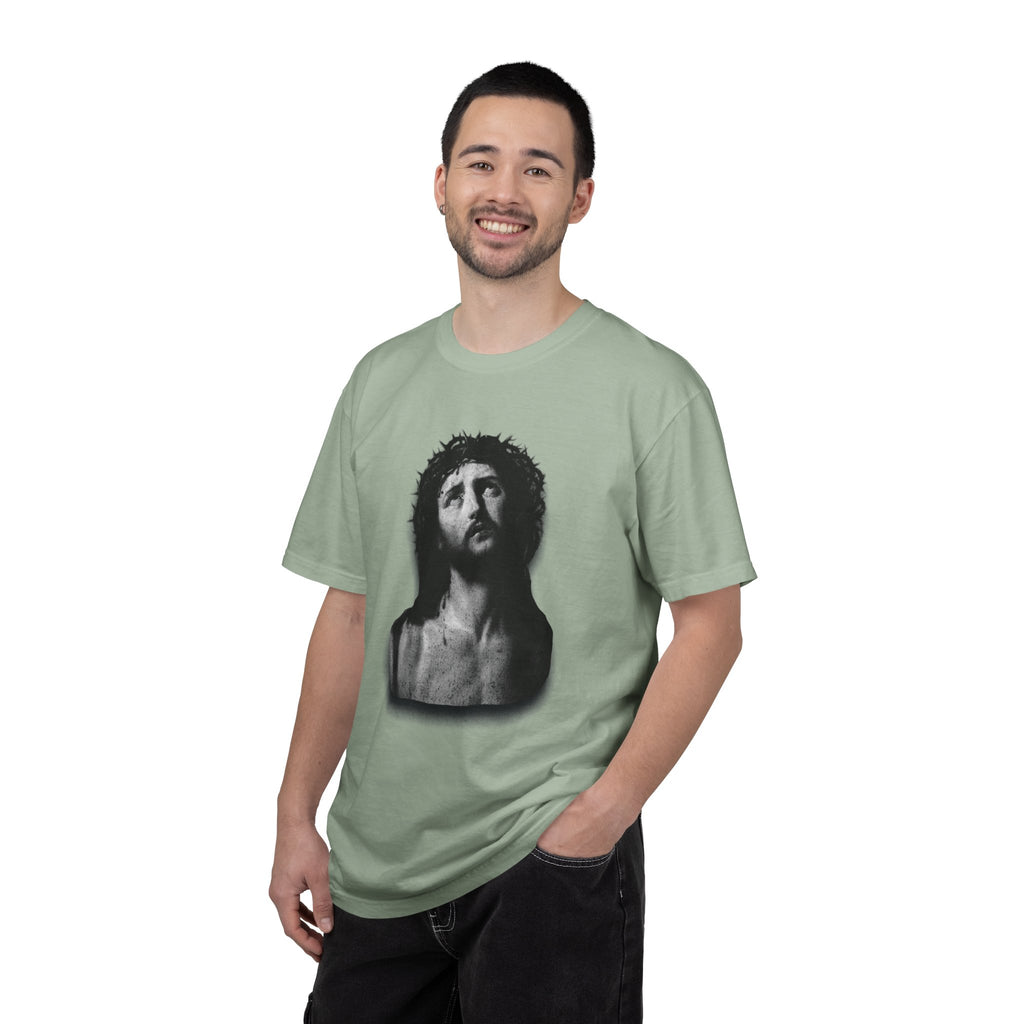 Man wearing a light green t-shirt with a graphic design on a white background