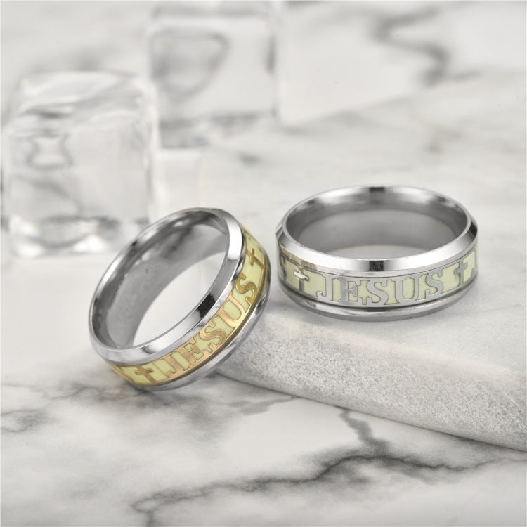 Two silver rings with engraved text on a marble surface