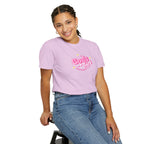 Person wearing a pink t-shirt with text and blue jeans on a white background