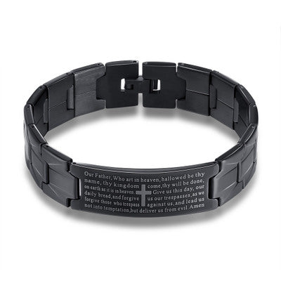 Black metal bracelet with engraved text on a white background