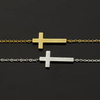Two gold and silver cross necklaces on a black background