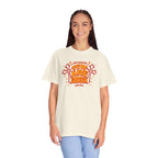 Person wearing a cream t-shirt with a colorful graphic design on a white background