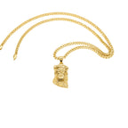 Gold necklace with a Jesus face pendant on a white background