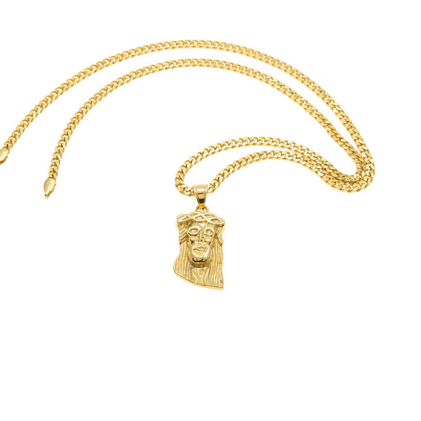 Gold necklace with a Jesus face pendant on a white background
