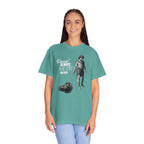 Person wearing a teal t-shirt with a graphic design and text on a white background