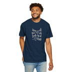 Man wearing a navy blue t-shirt with text and a cross graphic on a white background