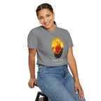 Person wearing a gray t-shirt with a colorful graphic design on a white background