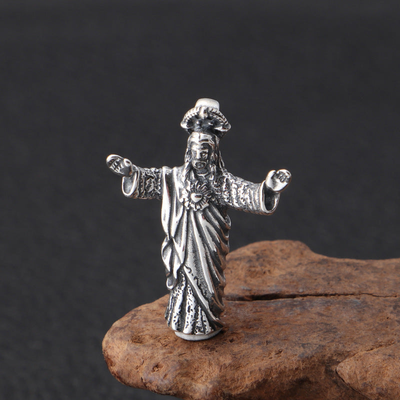 Silver figurine of a deity on a dark background