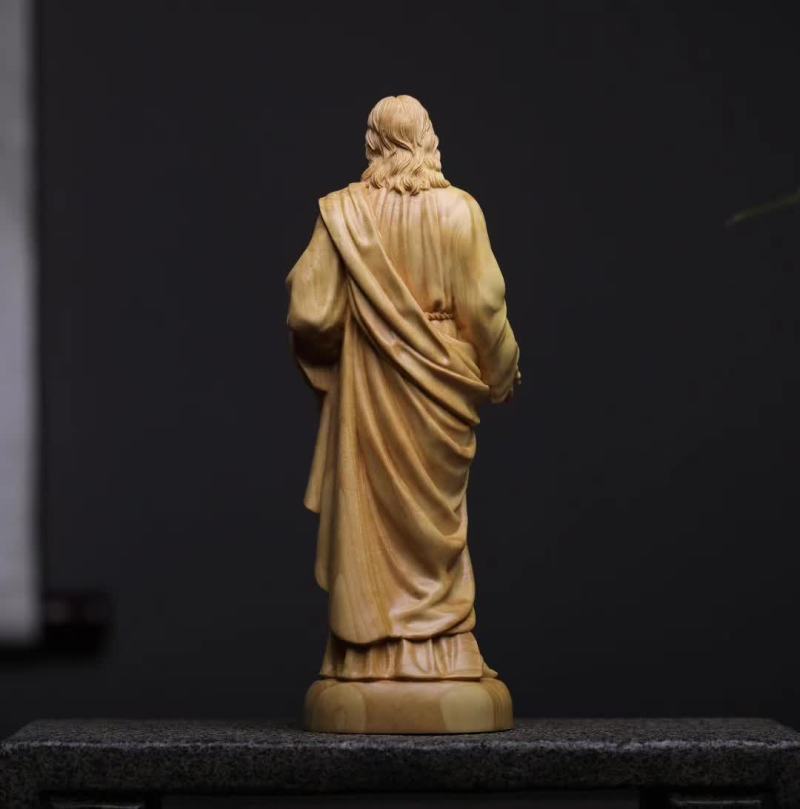 Statue of a robed figure on a dark background