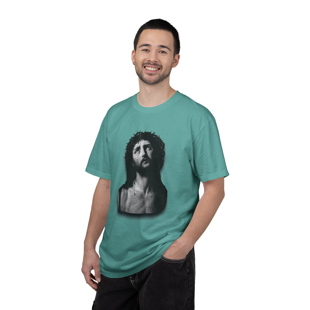 Man wearing a teal t-shirt with a graphic design on a white background
