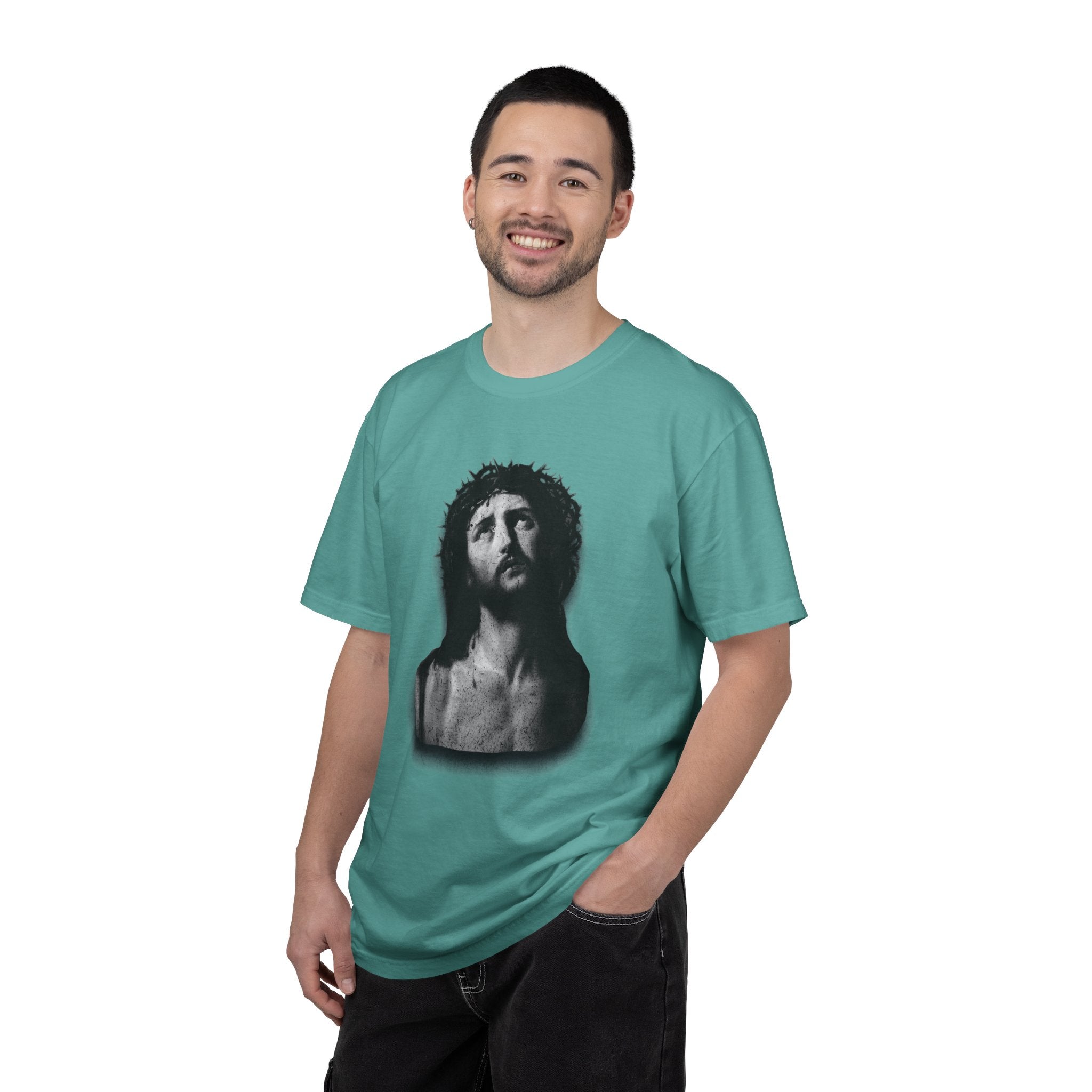 Man wearing a teal t-shirt with a graphic design on a white background