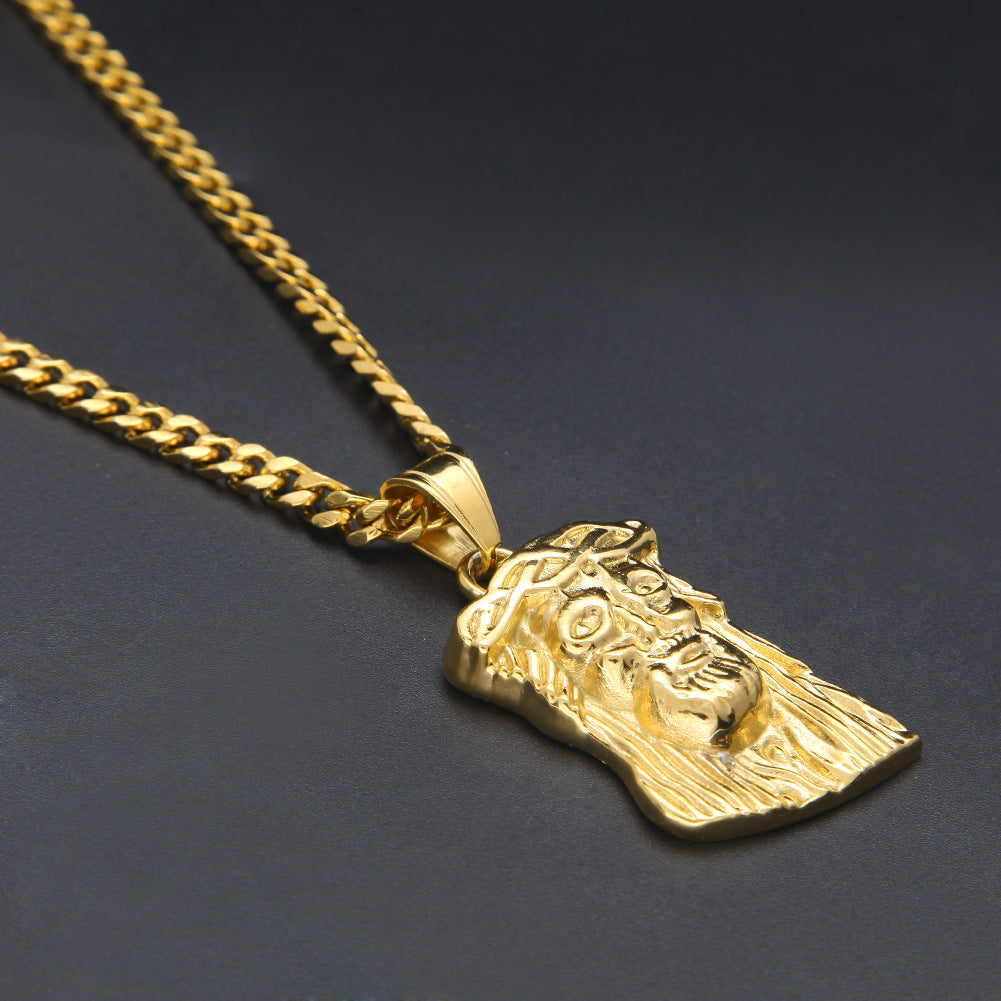 Gold necklace with a detailed pendant on a dark background