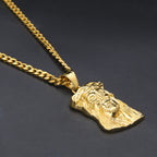 Gold necklace with a detailed pendant on a dark background