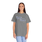 Person wearing a gray t-shirt with text on a white background