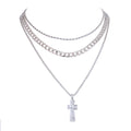 Silver chain necklaces with a cross pendant on a white background