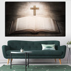 Living room with a green sofa, small table, and wall art of an open book with a cross.