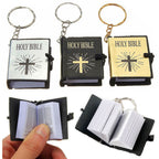 Set of mini Holy Bible keychains with different cover designs.