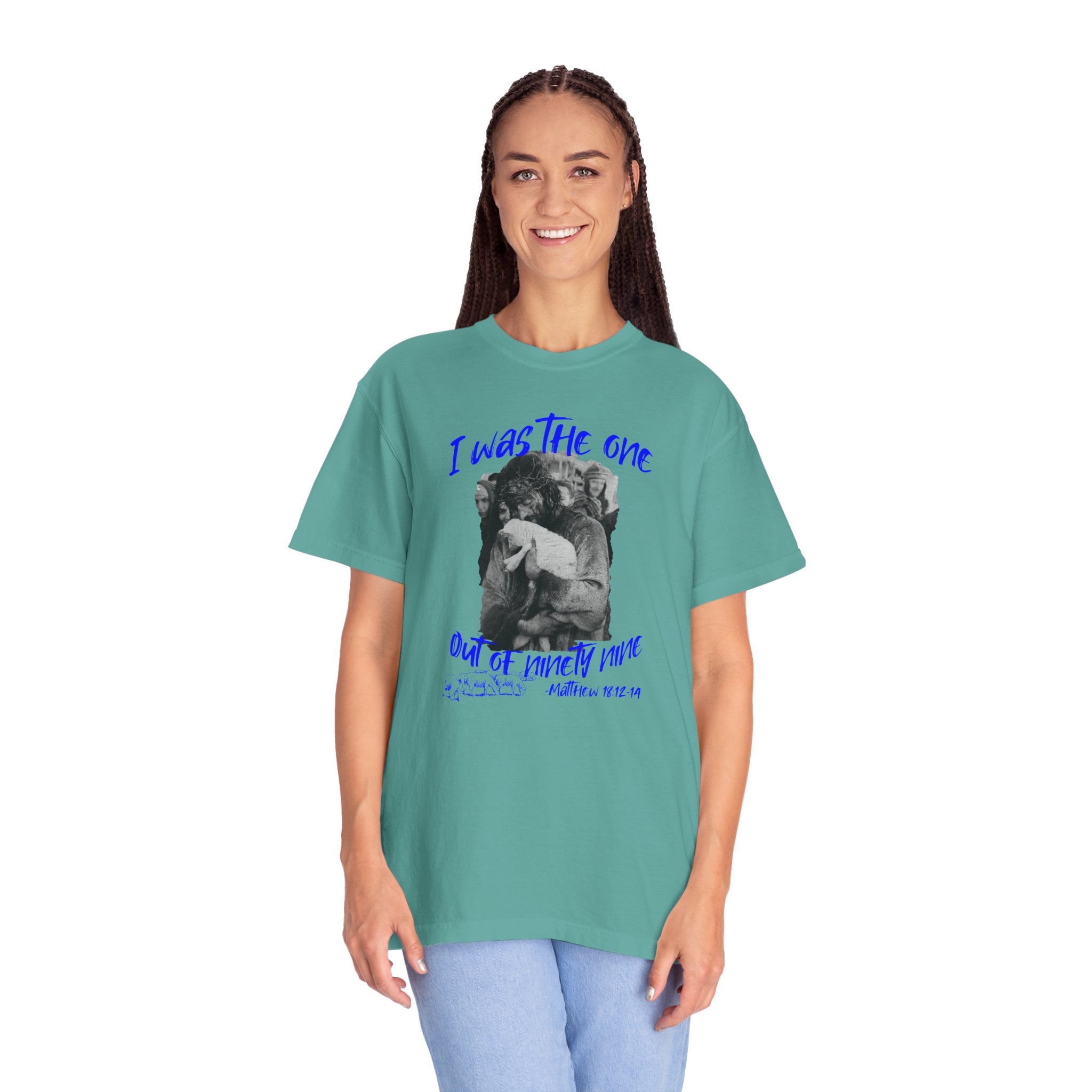 Person wearing a teal t-shirt with graphic design and text on a white background