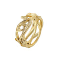 Gold ring with intricate design on a white background