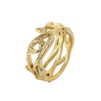 Gold ring with intricate design on a white background