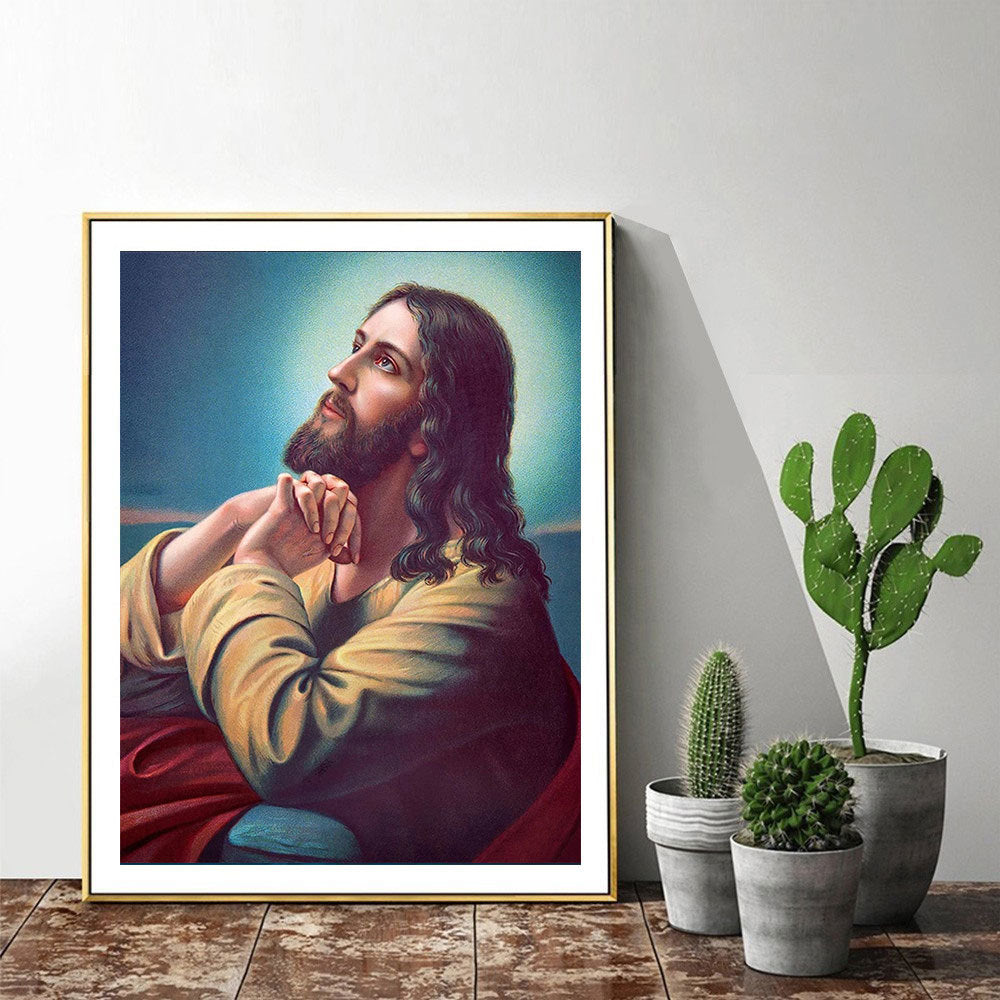 Framed artwork of a religious figure on a wall with potted plants below.