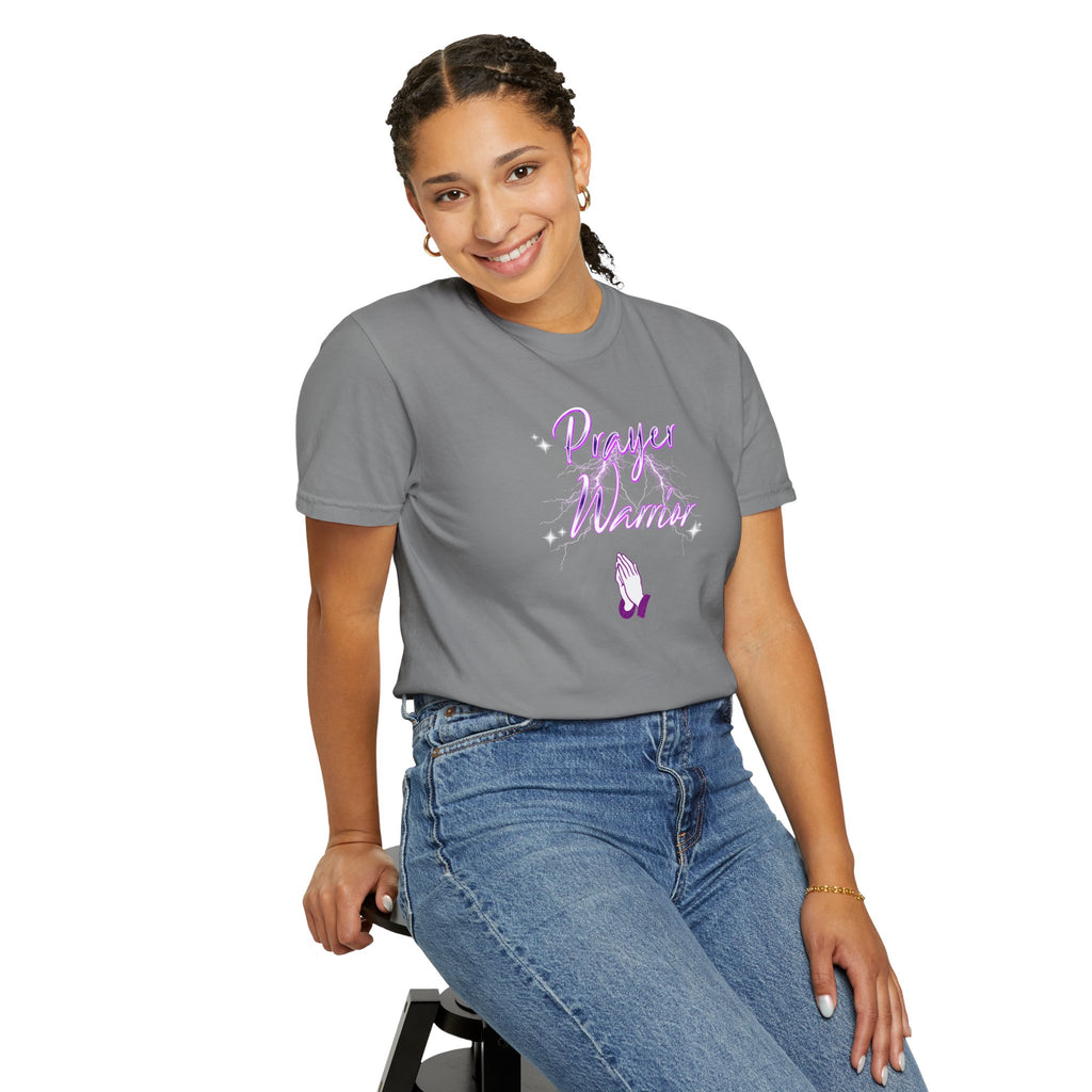 Person wearing a gray t-shirt with purple text and design, sitting on a stool against a white background