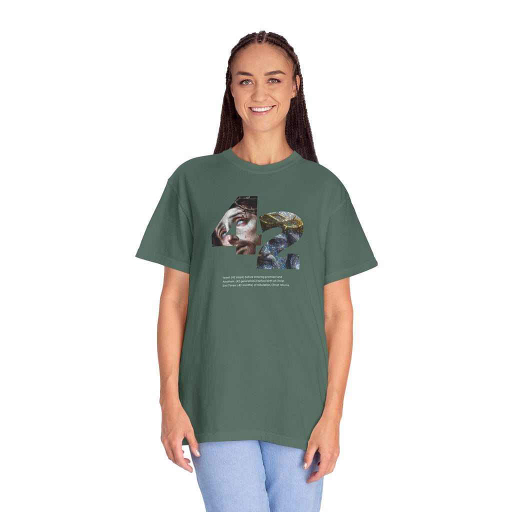 Person wearing a green t-shirt with a graphic design on a white background