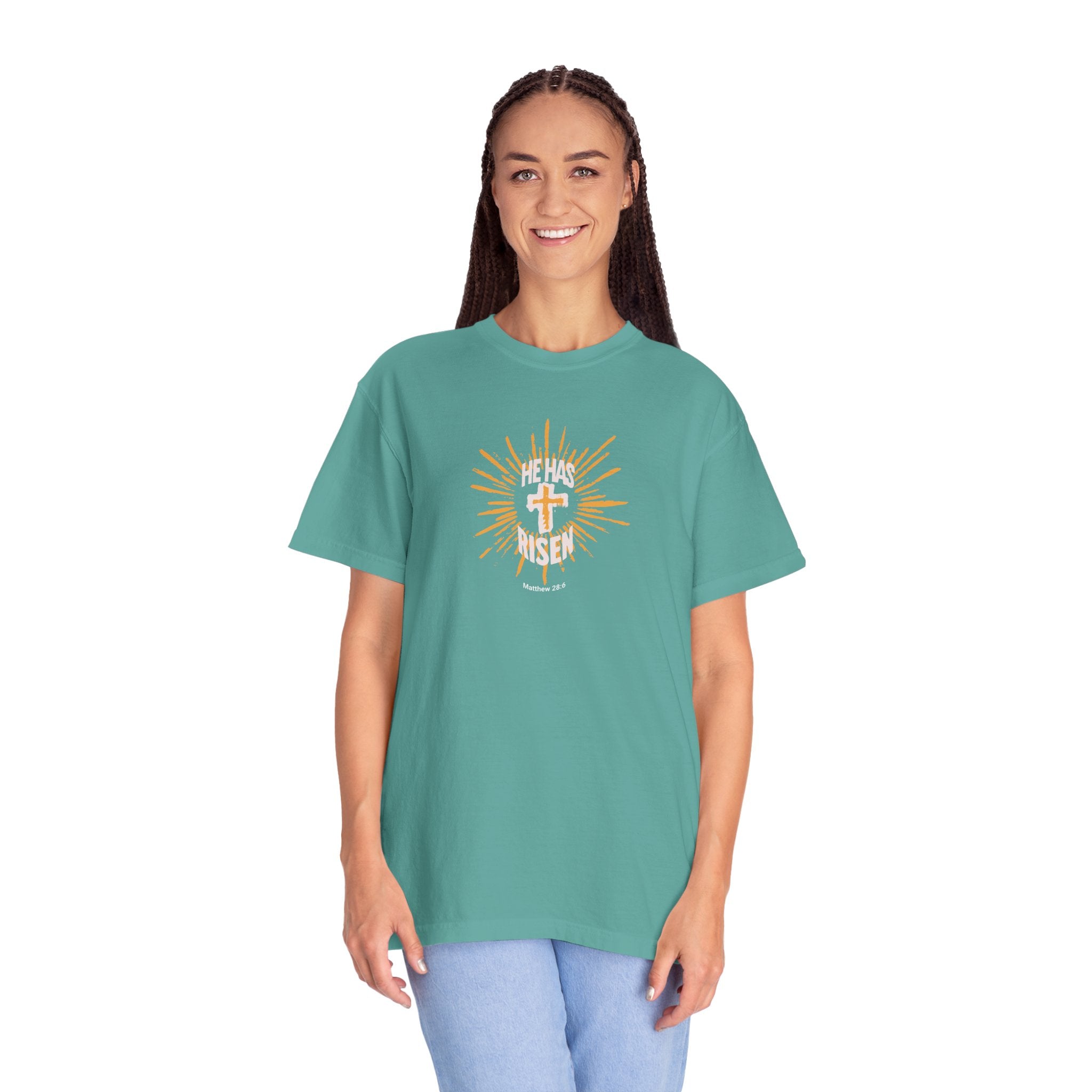 Woman wearing a teal t-shirt with a graphic design on a white background
