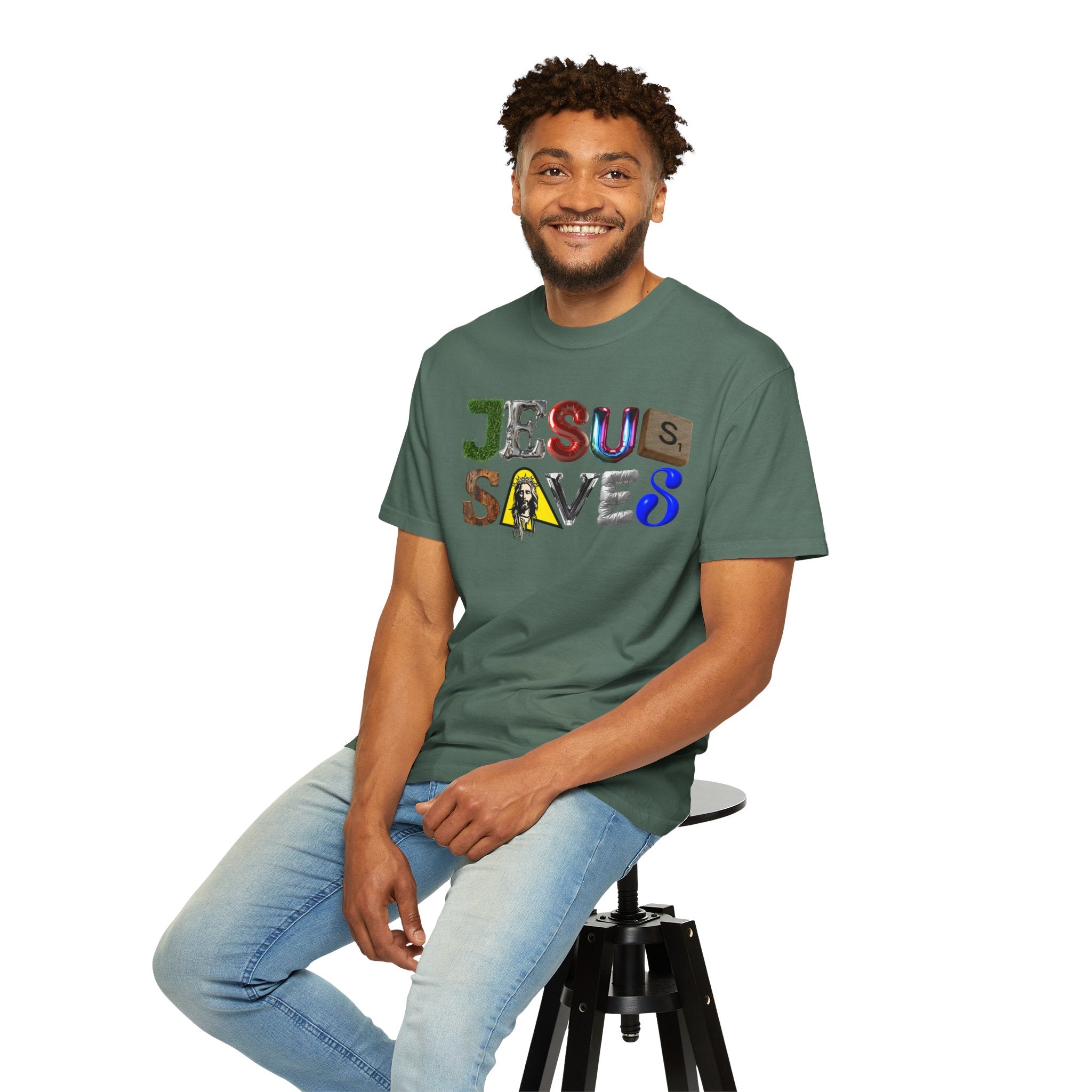 Man wearing a green t-shirt with 'Jesus Saves' text, sitting on a stool against a white background