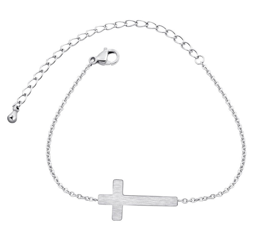 Silver bracelet with a cross charm on a white background