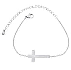 Silver bracelet with a cross charm on a white background