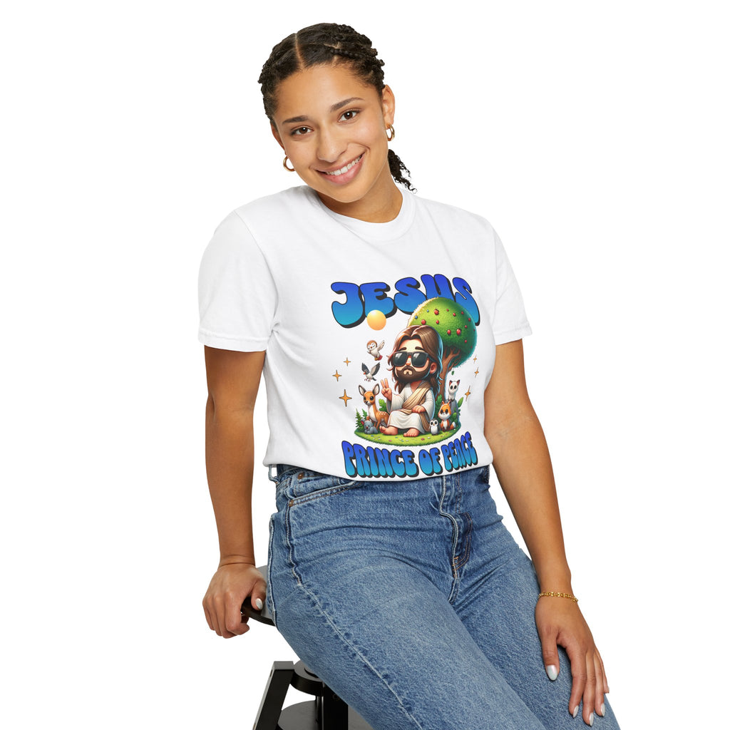 Person wearing a white t-shirt with colorful graphics and text, sitting on a stool against a white background.