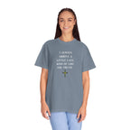 Person wearing a gray t-shirt with a graphic design on a white background