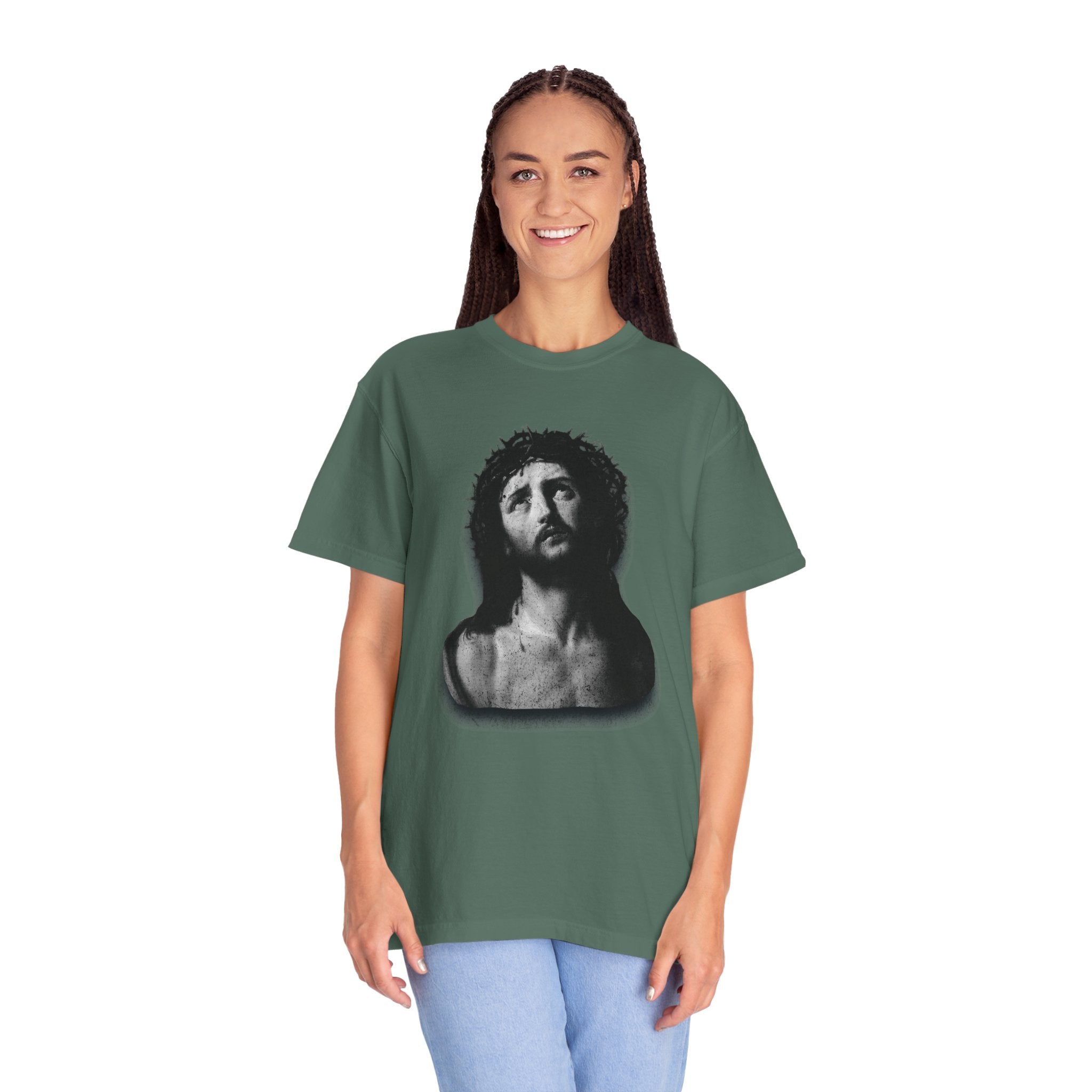 Person wearing a green t-shirt with a graphic design on a white background