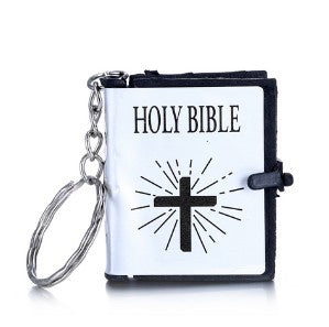 Keychain with a miniature Bible design featuring a cross on a white background