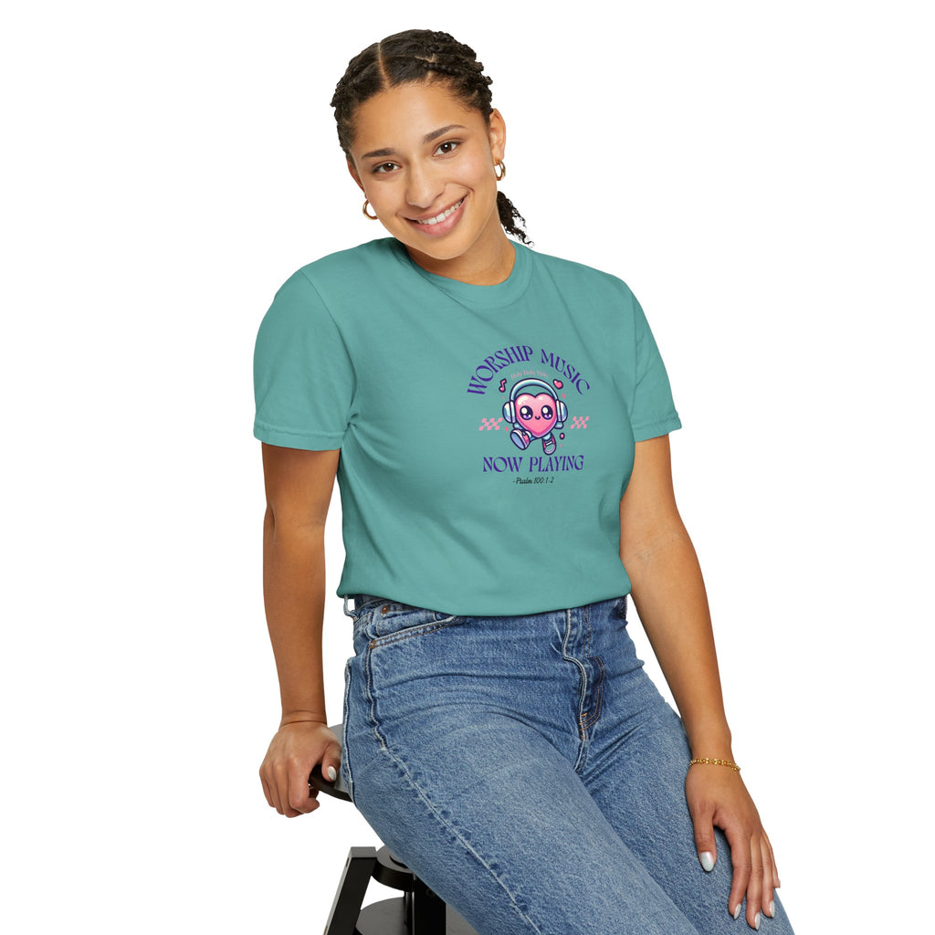 Person wearing a teal t-shirt with a graphic design on a white background