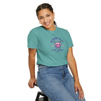 Person wearing a teal t-shirt with a graphic design on a white background