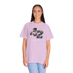 Person wearing a light purple t-shirt with a graphic design on a white background