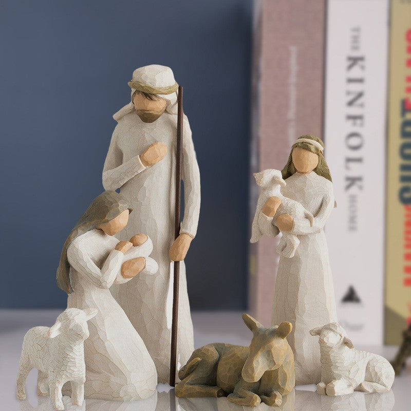 Wooden nativity scene figurines with a dark blue background