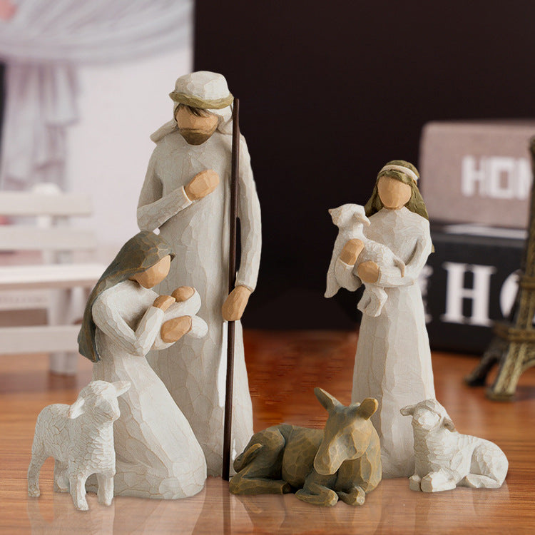 Decorative nativity scene with figures on a wooden surface