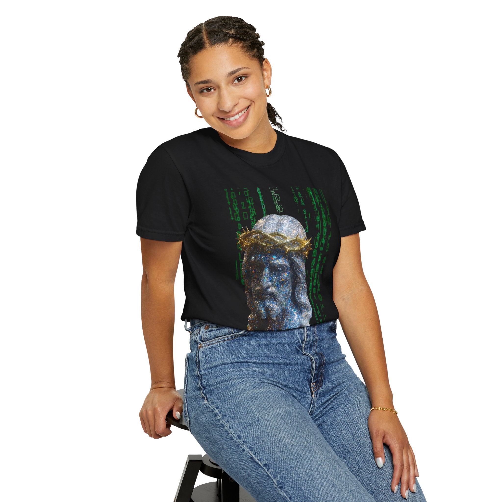 Person wearing a black t-shirt with a graphic design sitting on a stool against a white background