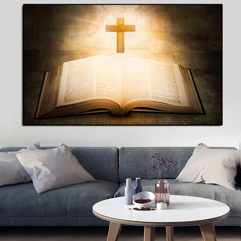 Living room with an open book and cross painting above a gray sofa.