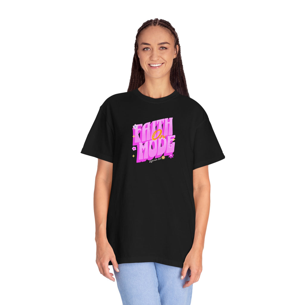 Person wearing a black t-shirt with pink and yellow text on a white background