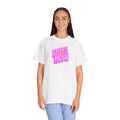 Person wearing a white t-shirt with pink text on a white background