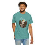 Man wearing a teal t-shirt with a graphic design on a white background